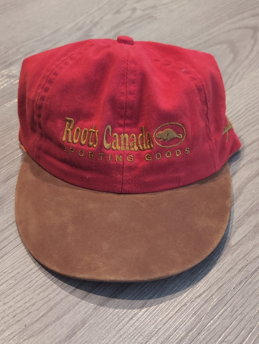 Roots red cap with orange trim and gold embroidery